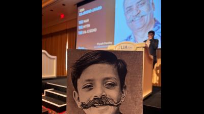 LIA creating the iconic moustache on Piyush's picture from his younger days. LIA creating the iconic moustache on Piyush's picture from his younger days.